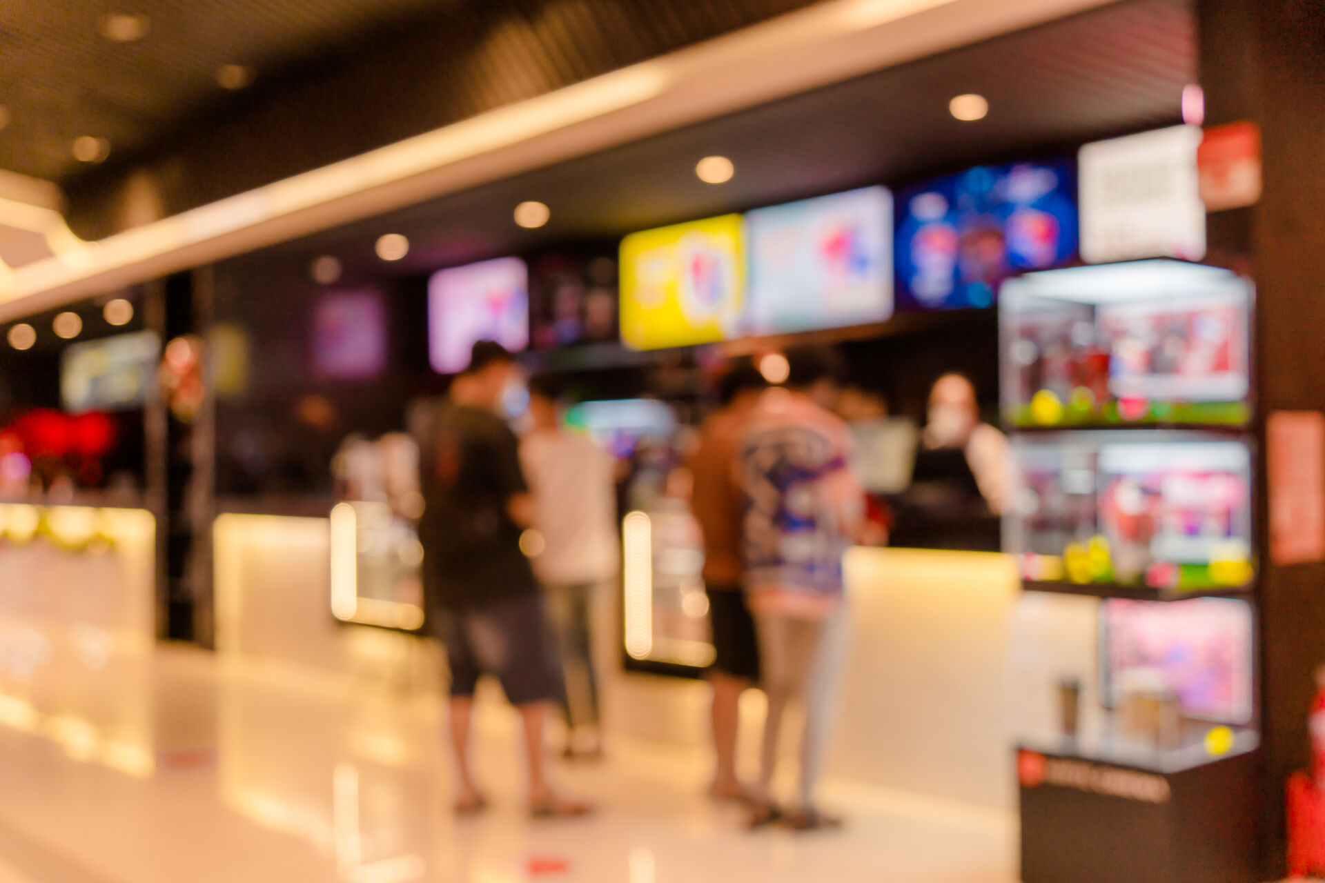 Out of focus cinema kiosk shot with AV displays